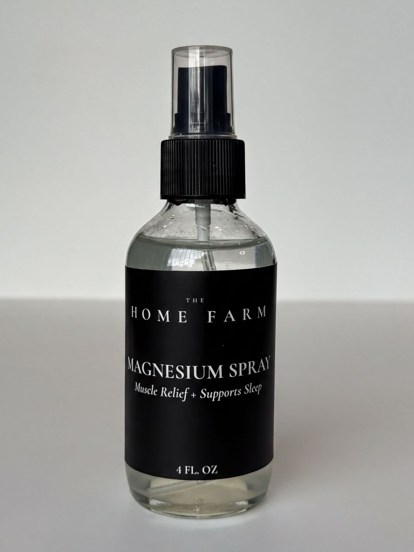 a bottle of magnesium spray with a black label.