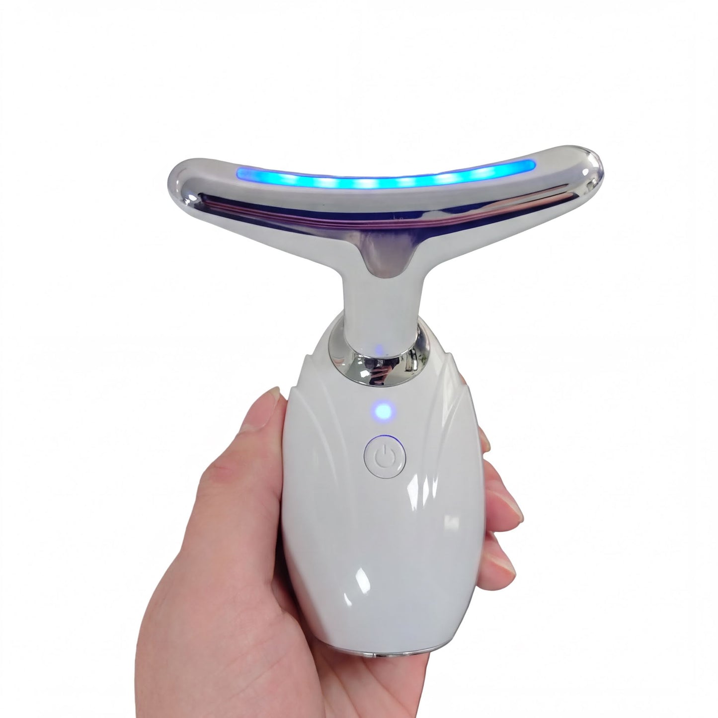 A hand holding a white electronic device with a blue light on it.