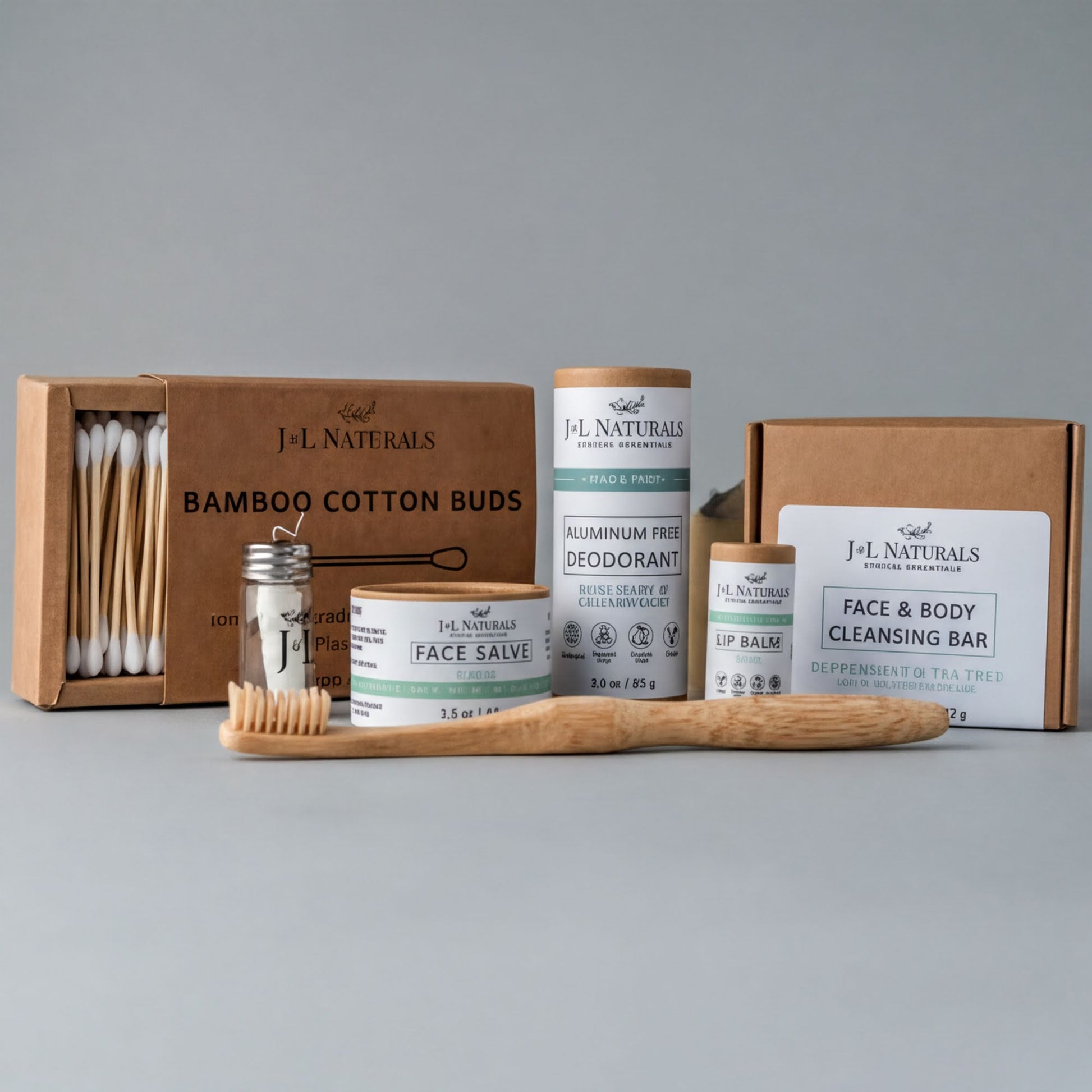 a collection of natural beauty products, including a bamboo toothbrush, a face balm, a deodorant, and a face and body cleansing bar, all packaged in cardboard boxes.