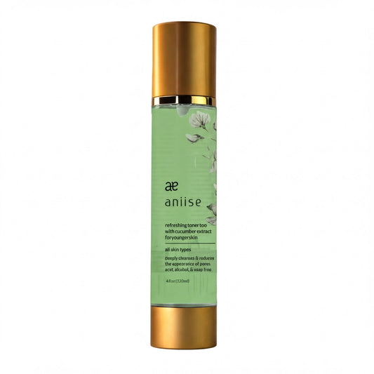 A bottle of anise-based skincare product with a green label and gold cap.