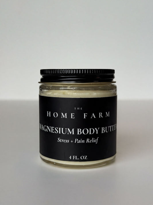 A jar of magnesium body butter with a black lid, labeled as a stress and pain relief product.