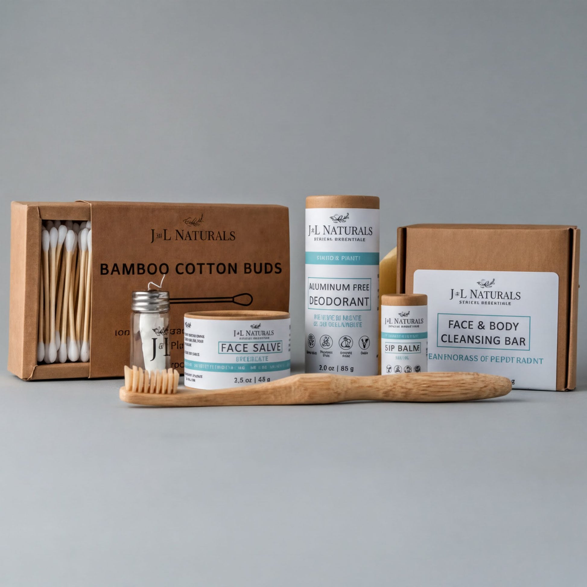 a collection of natural beauty products, including a bamboo toothbrush, a face balm, a deodorant, and a face cleansing bar, all packaged in cardboard boxes.