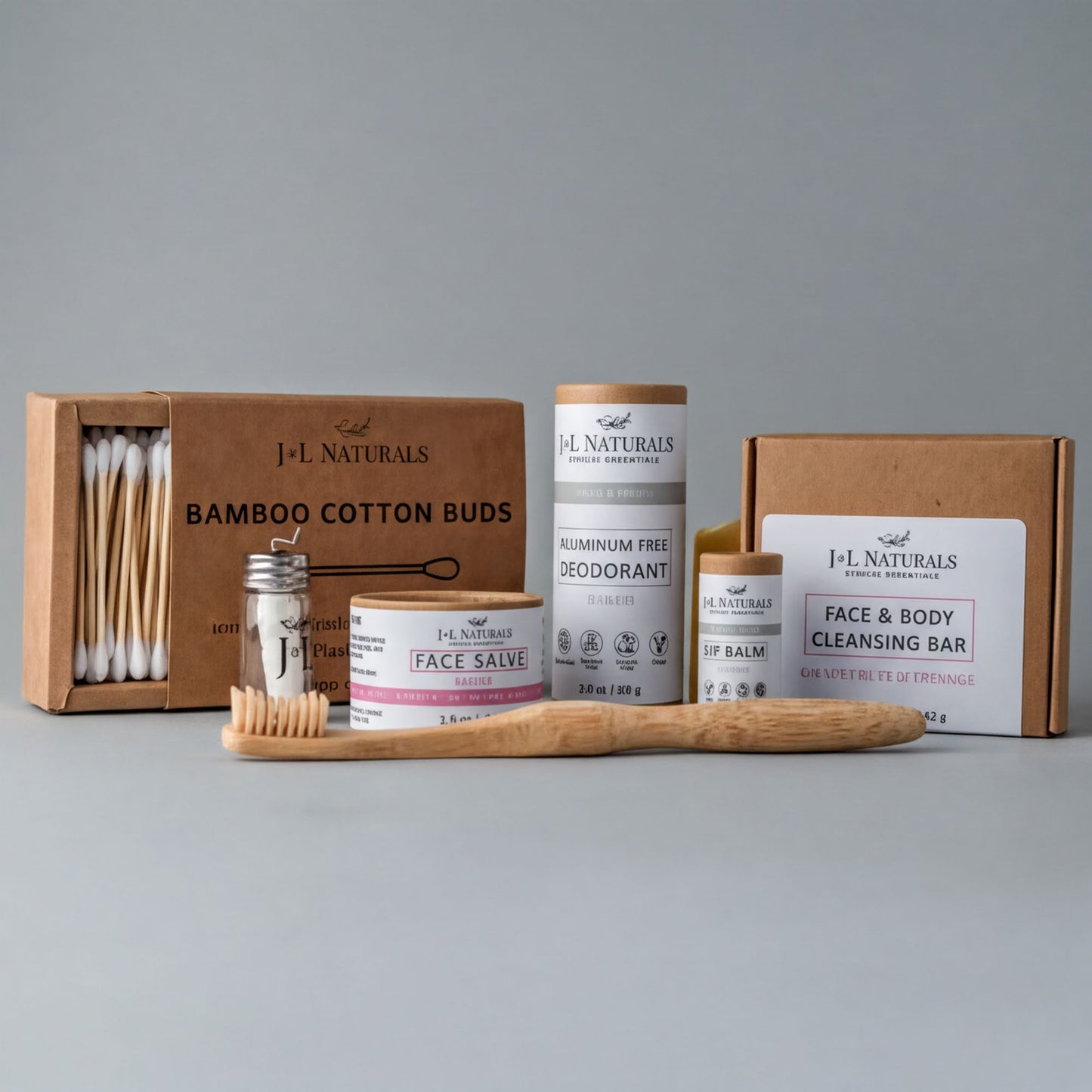 a collection of natural beauty products, including a box of bamboo cotton buds, a tube of aluminum-free deodorant, a jar of face balm, and a box of a face and body cleansing bar.