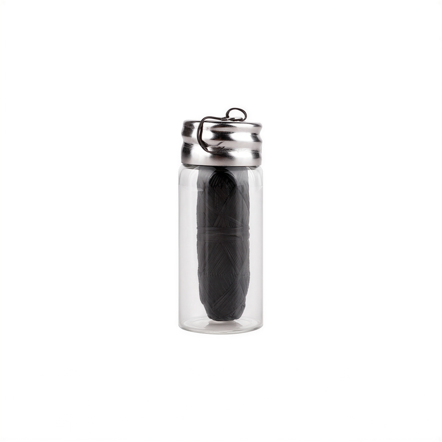A clear glass bottle with a metal cap and a black object inside.