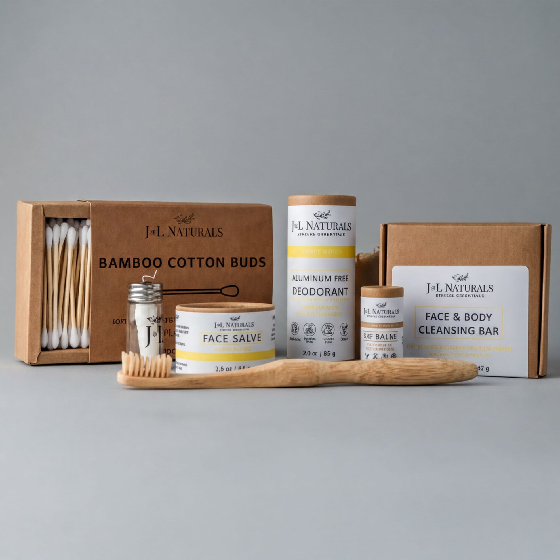 a collection of natural beauty products, including a bamboo toothbrush, a box of bamboo cotton buds, a jar of face balm, and a box of aluminum-free deodorant.