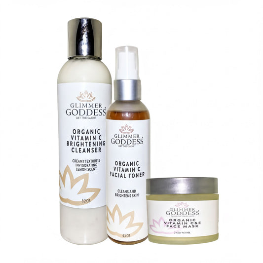 three beauty products from the brand "Glimmer Goddess" arranged in a row, with a focus on their organic vitamin C-based skincare line.